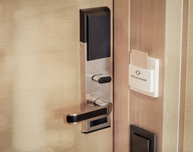 Electronic Card Smart Lock On Wooden Door At The Hotel For Power